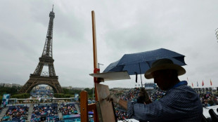 Olympic beach volleyball starts in drenching rain under Eiffel Tower