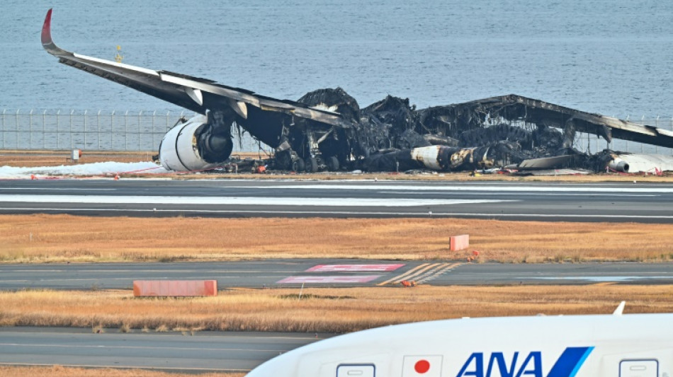 Japan investigators probe conflicting reports on fiery Tokyo crash