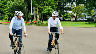 New Australia PM, Indonesia president ride bikes as diplomatic wheels turn